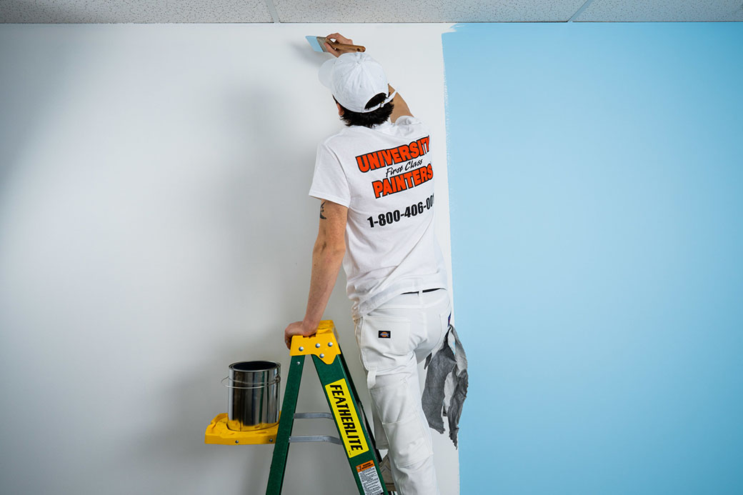 painter from ufcp working on a white wall