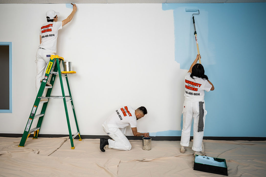 3 painting contractors form ufcp working on a commercial project from white to blue