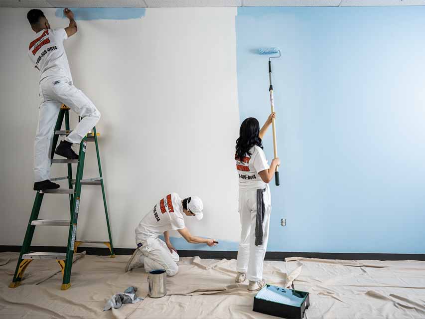 student manages painting the interior of a house